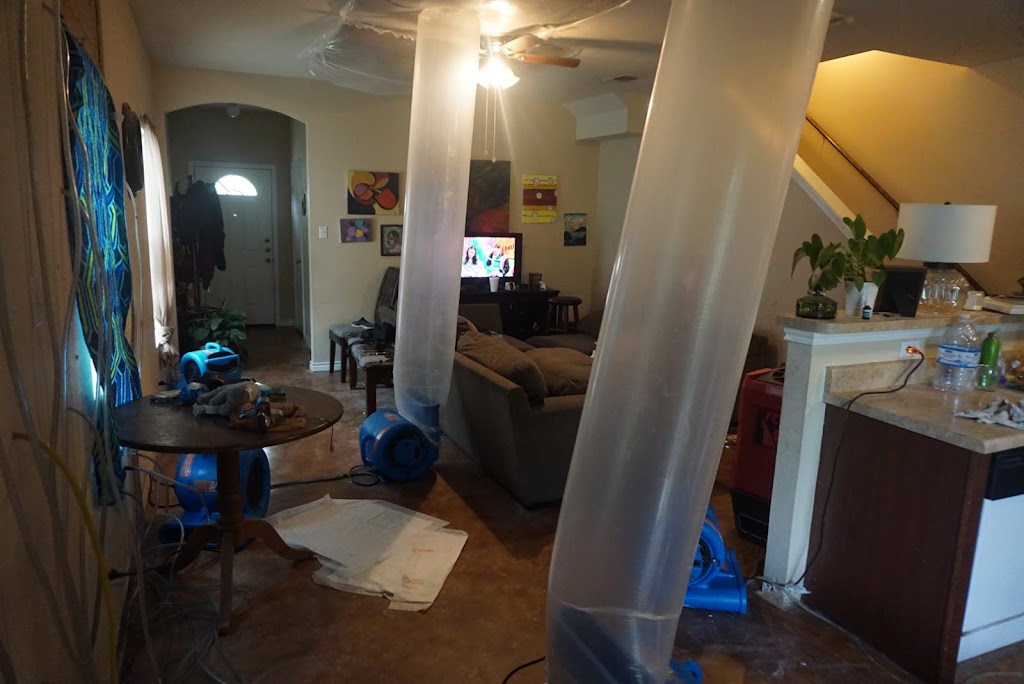 fans being ducted into ceiling cavity for drying