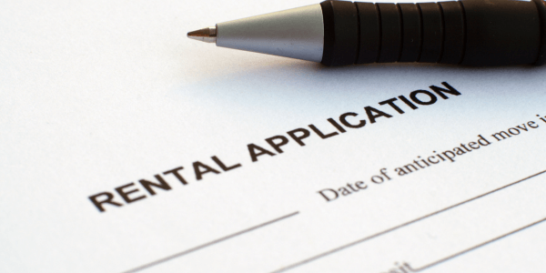 rental application with pen that requires renters insurance