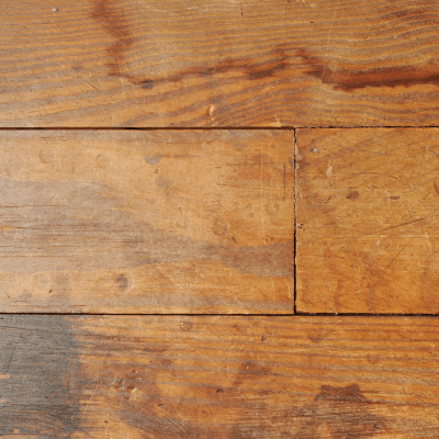 Signs of water damage on hardwood floors with water stains