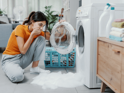 woman surprised to see her Broken washing machine overflow